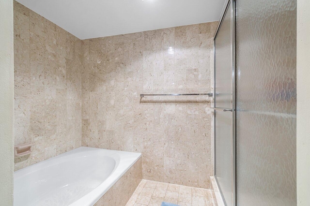 bathroom with shower with separate bathtub