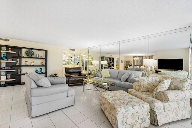 tiled living room featuring a textured ceiling