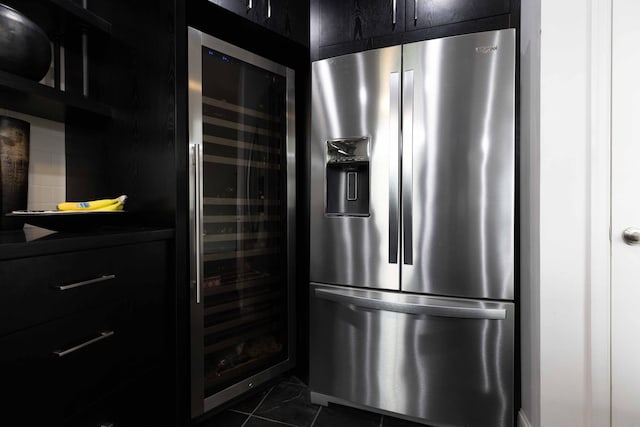 kitchen with stainless steel fridge, beverage cooler, and dark tile patterned flooring