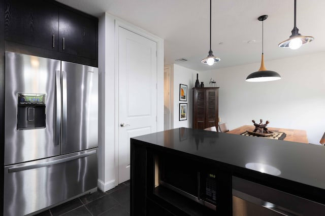 kitchen with stainless steel fridge with ice dispenser, dark tile patterned floors, and hanging light fixtures