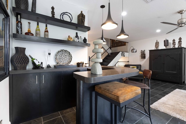 bar with hanging light fixtures and ceiling fan