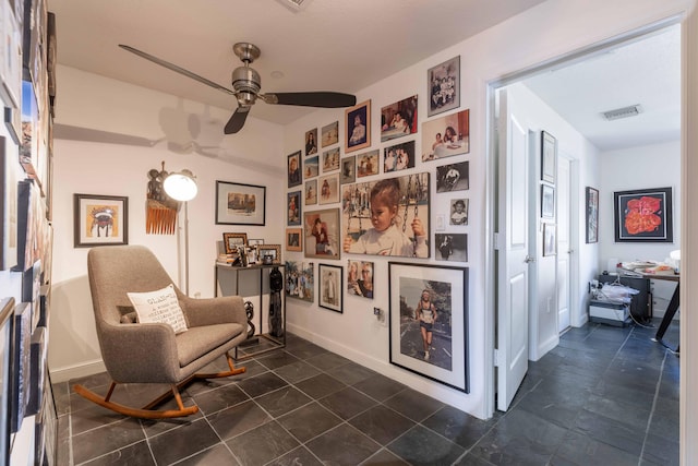 sitting room featuring ceiling fan