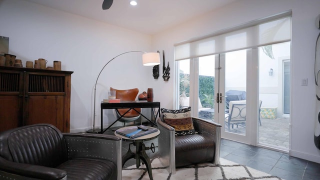 living area featuring french doors and tile patterned flooring