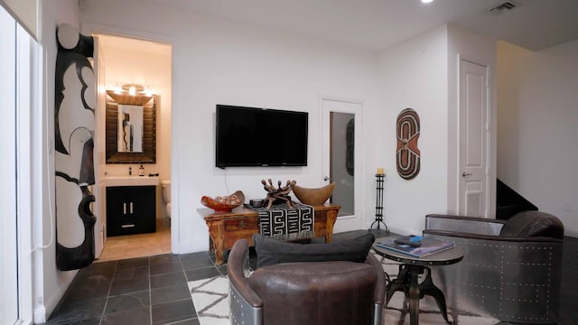 living room featuring dark tile patterned floors