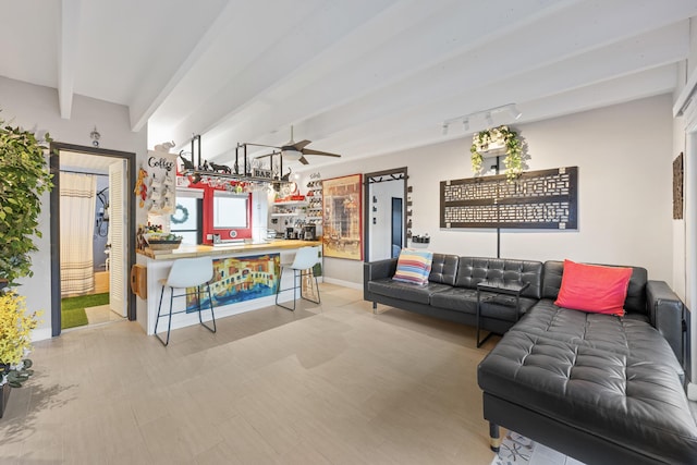 living room featuring track lighting, ceiling fan, and beam ceiling