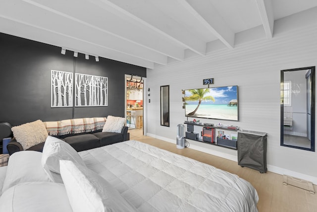 bedroom featuring beam ceiling and light wood-type flooring