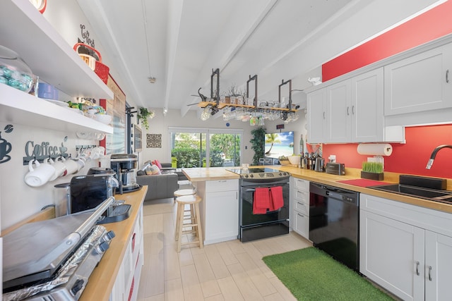 kitchen featuring white cabinetry and butcher block counters