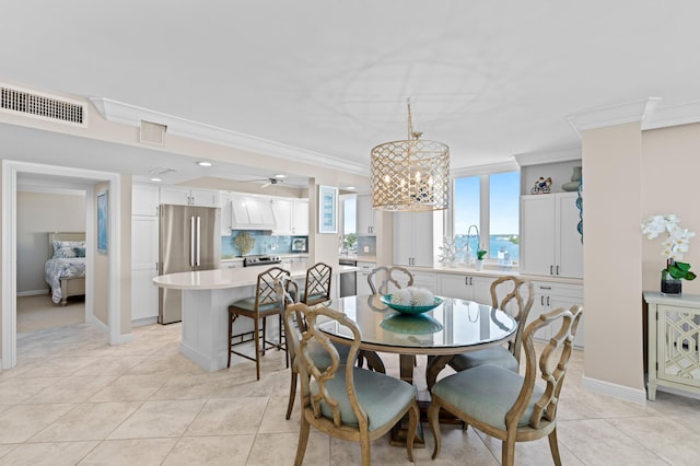 dining area with ceiling fan with notable chandelier, crown molding, and light tile patterned flooring