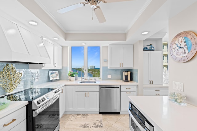 kitchen with sink, backsplash, white cabinetry, and appliances with stainless steel finishes