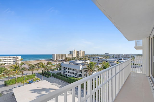 balcony with a water view and a beach view