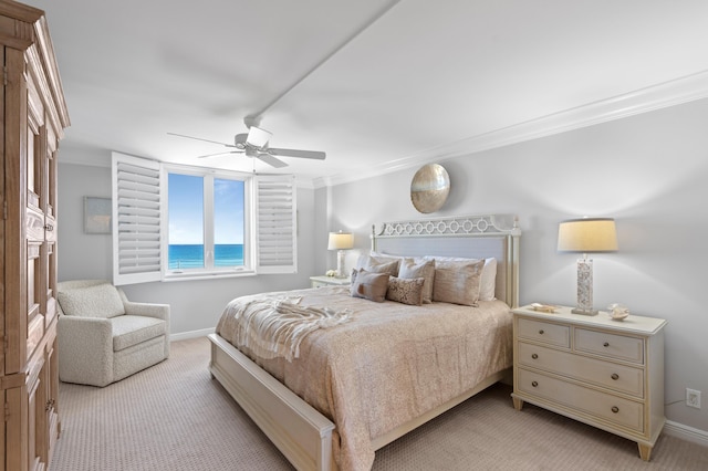 bedroom with ceiling fan, light carpet, ornamental molding, and a water view