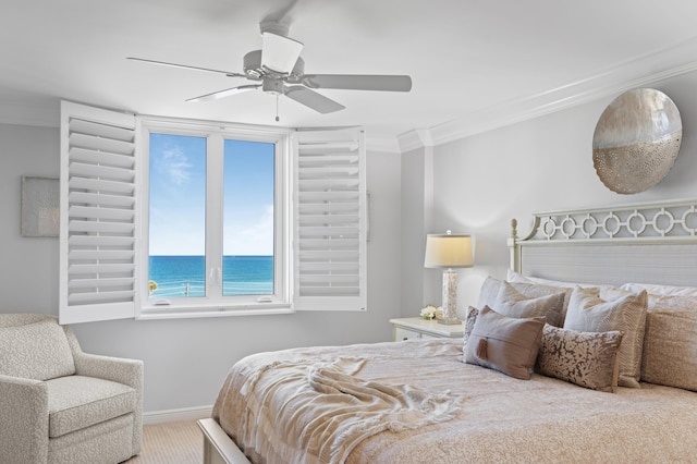 bedroom featuring ceiling fan, a water view, ornamental molding, and multiple windows