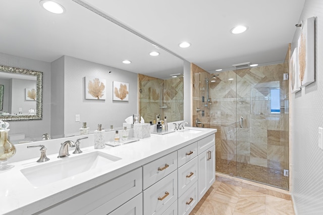 bathroom featuring walk in shower and vanity