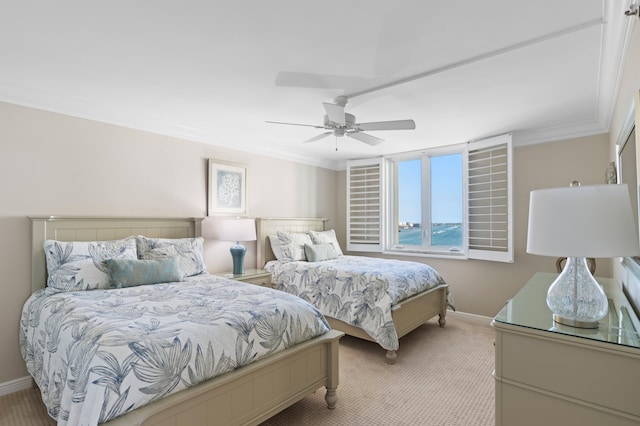 carpeted bedroom with ceiling fan and ornamental molding