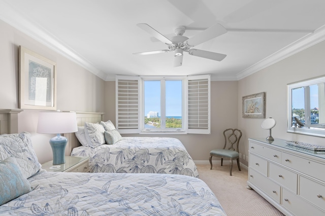 bedroom with ceiling fan, crown molding, and light carpet