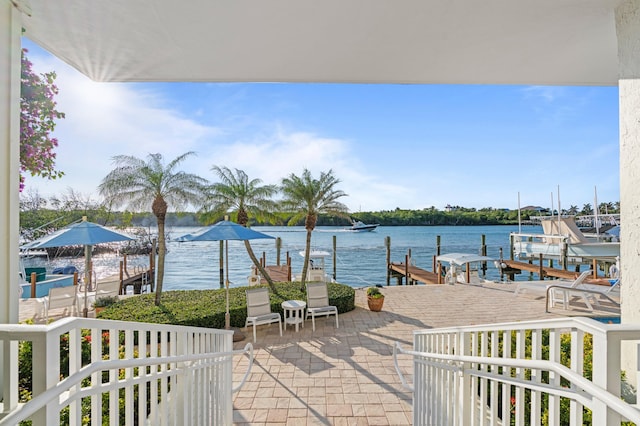 view of patio / terrace featuring a boat dock and a water view