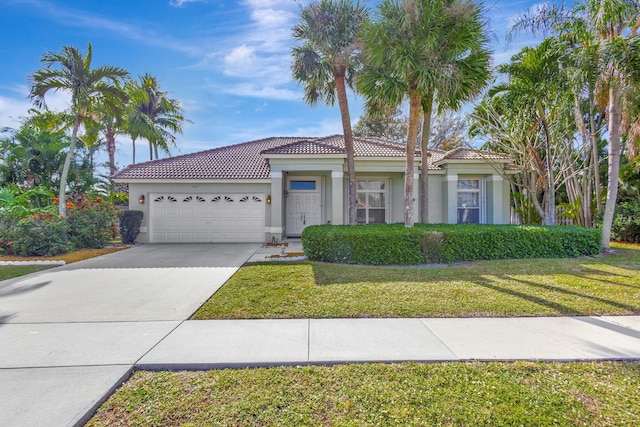 mediterranean / spanish-style home featuring a garage and a front lawn