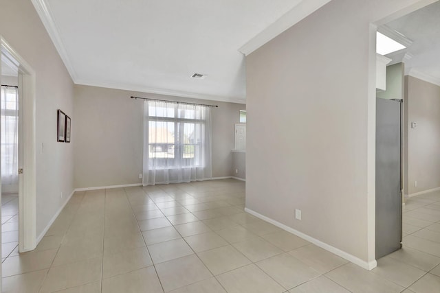 spare room with light tile patterned flooring and crown molding