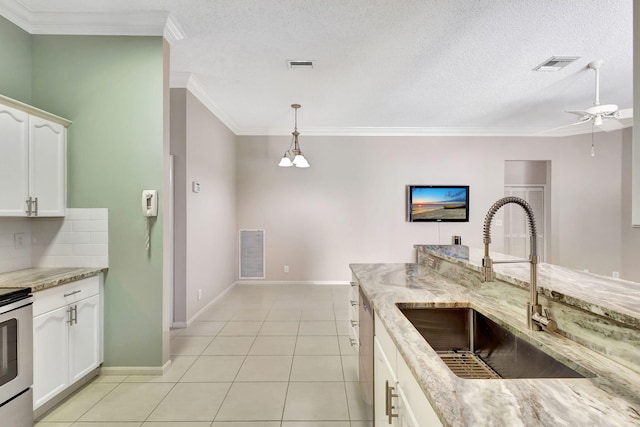 kitchen featuring pendant lighting, white cabinetry, sink, and light stone counters