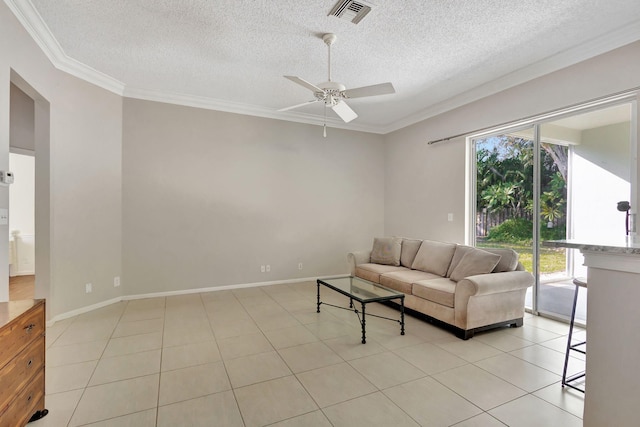 tiled living room with ceiling fan, a textured ceiling, and ornamental molding