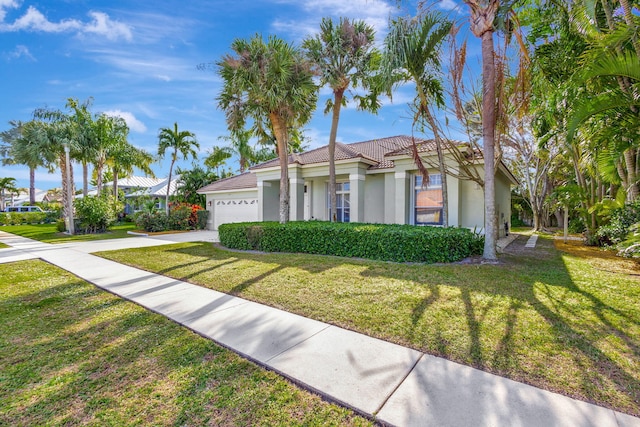 view of front of house with a front yard and a garage