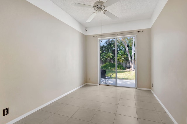 tiled spare room featuring ceiling fan and a textured ceiling