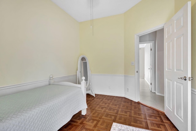 bedroom featuring dark parquet floors