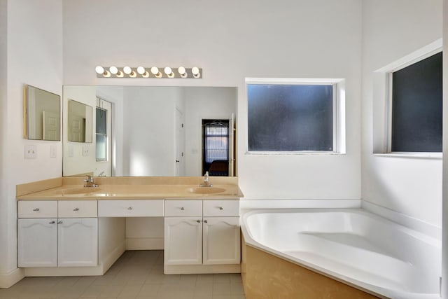 bathroom featuring tile patterned floors, vanity, and a bath