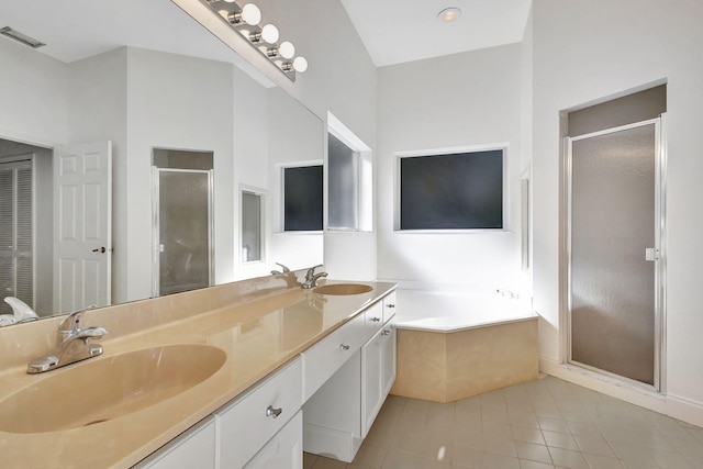 bathroom featuring tile patterned flooring, vanity, and shower with separate bathtub