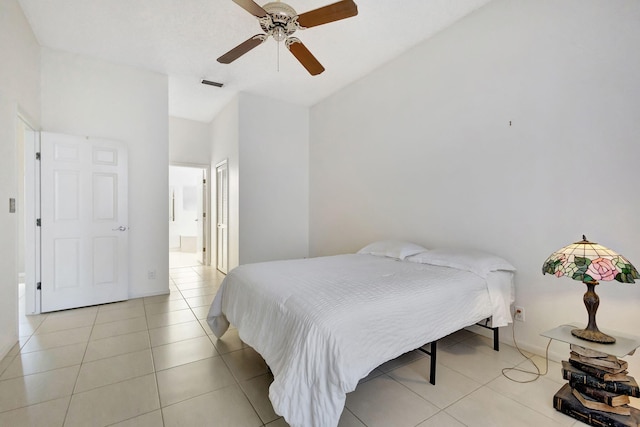 tiled bedroom featuring ceiling fan