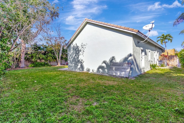 view of side of home featuring a yard