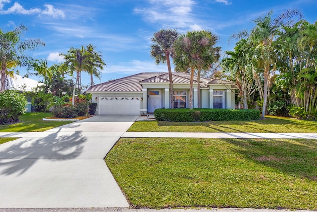 view of front facade featuring a front yard and a garage