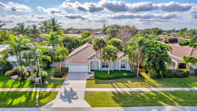 view of front of home with a front lawn and a garage