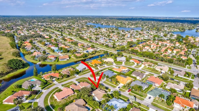 birds eye view of property with a water view