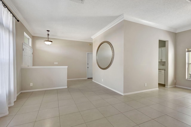 unfurnished room with ornamental molding, a textured ceiling, and light tile patterned floors