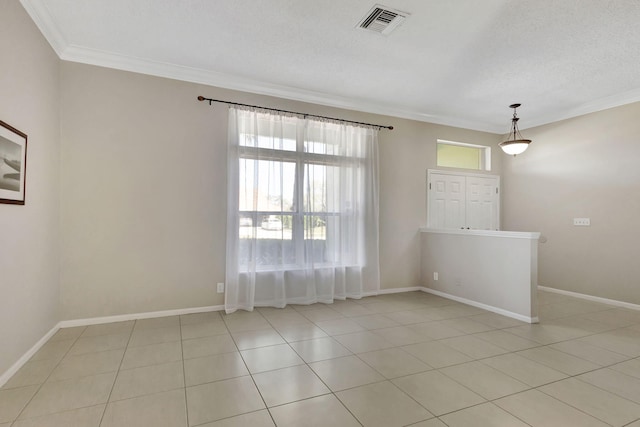 tiled empty room featuring a textured ceiling