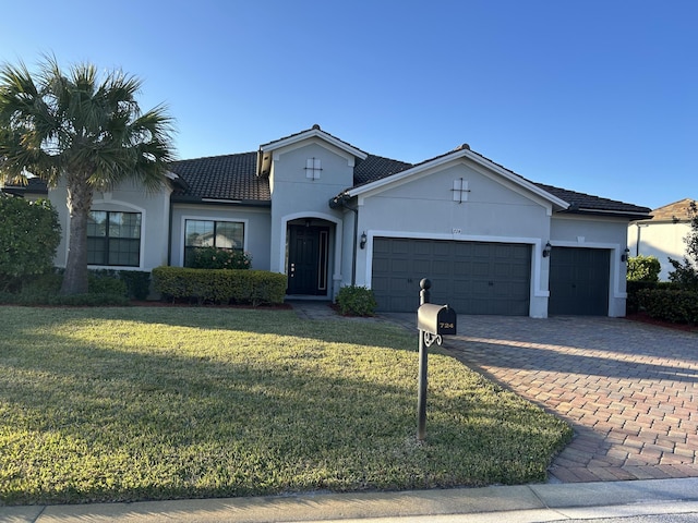 view of front of house with a garage and a front yard