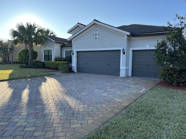 view of front of house featuring a garage and a front lawn