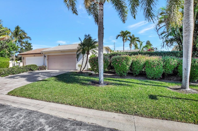 view of front of house with a front lawn and a garage