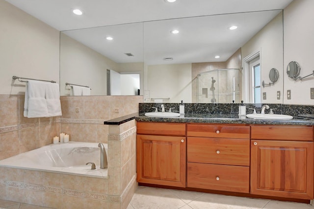 bathroom featuring vanity, tile patterned flooring, and plus walk in shower