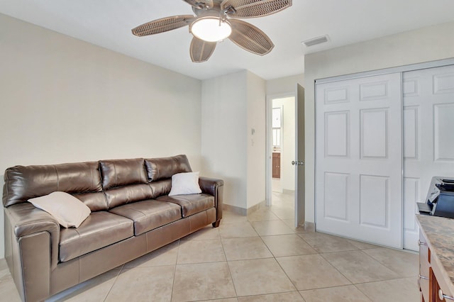 living room with ceiling fan and light tile patterned floors