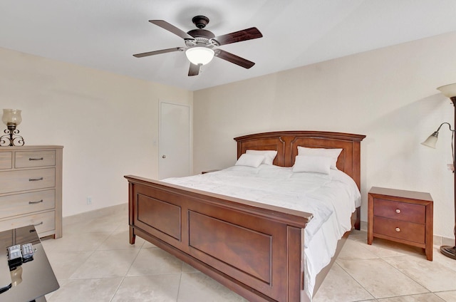 tiled bedroom featuring ceiling fan