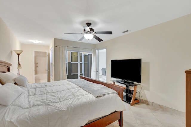 bedroom featuring ceiling fan, light tile patterned flooring, and ensuite bathroom