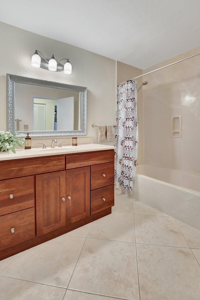 bathroom featuring tile patterned floors, a textured ceiling, vanity, and shower / tub combo