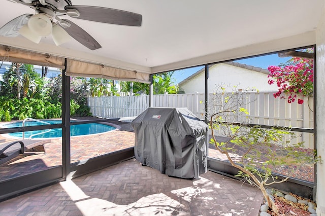 sunroom featuring ceiling fan