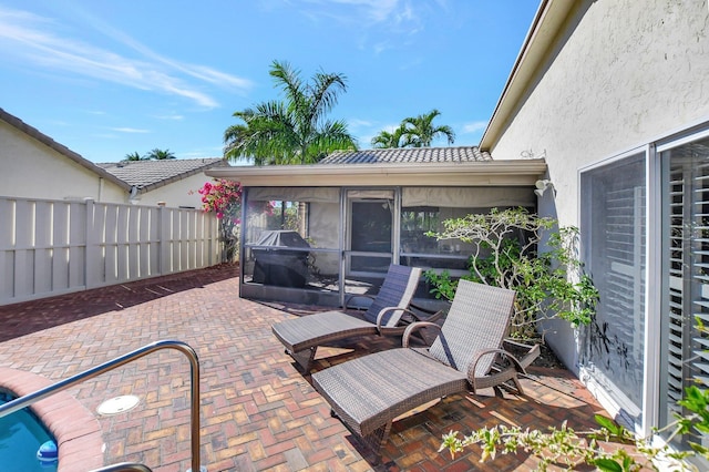 view of patio / terrace featuring a sunroom