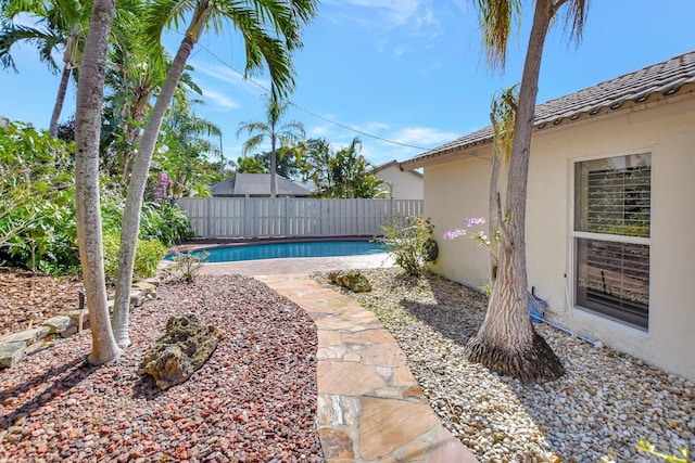 view of yard with a fenced in pool