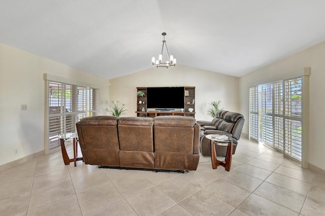 living room with an inviting chandelier, light tile patterned floors, a wealth of natural light, and vaulted ceiling