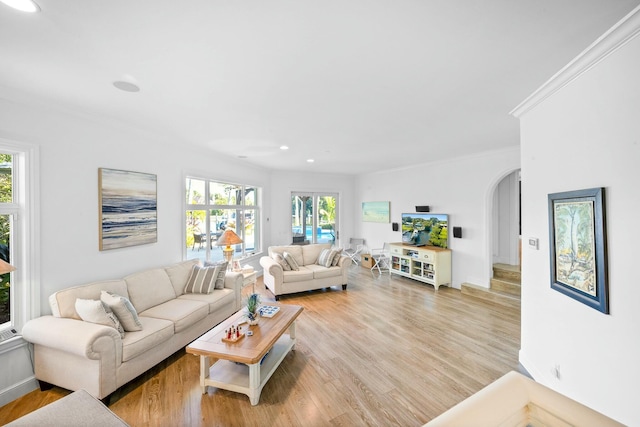 2897 SE Saint Lucie Blvd, Stuart, FL 34997 - living room featuring light wood-style floors, arched walkways, recessed lighting, baseboards, and ornamental molding
