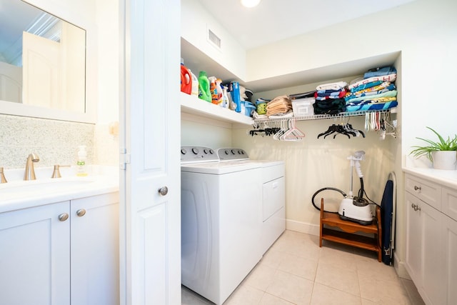 2897 SE Saint Lucie Blvd, Stuart, FL 34997 - washroom with laundry area, visible vents, washing machine and clothes dryer, light tile patterned floors, and a sink